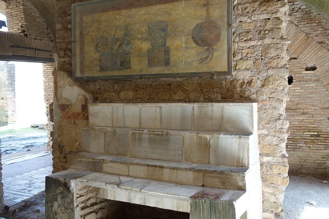 Ancient Ostia Antica Semi-Private Day Trip from Rome by Train with Guide - Forum of the Corporations, Temples, Taverns, and the Port-City Economy