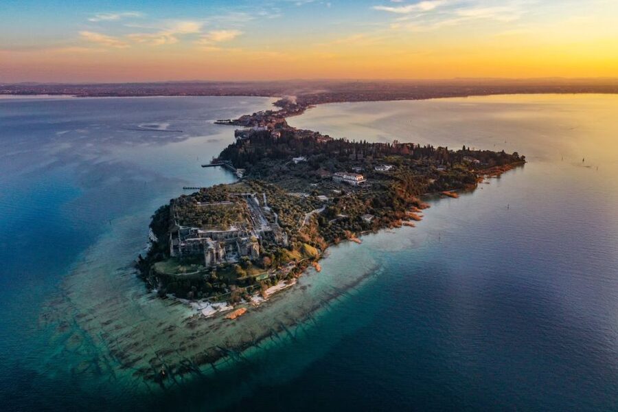 Desenzano del Garda: Sunset Boat Trip at Sunset with Drink - Sirmione from the water, including the castle view