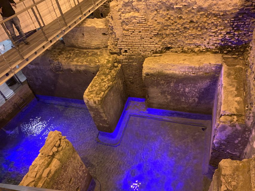Rome: Trevi Fountain District Underground Domus Guided Tour - Luxury domus life: coins, amphorae, and polychrome marble